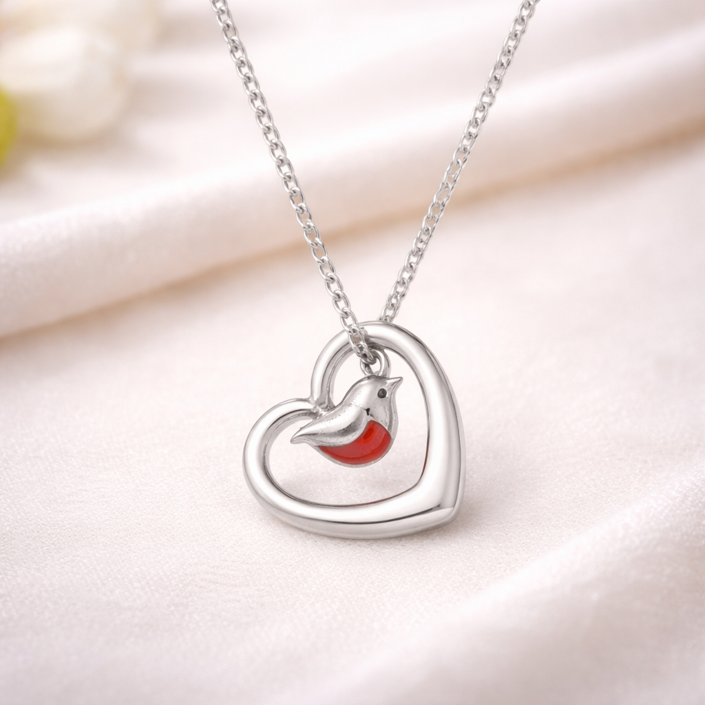 Lady wearing a robin necklace with a robin in the foreground. Part of our robin jewellery collection which includes robin earrings and robin bracelet