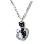 bigger crystal black cat and smaller crystal white cat in a crystal heart pendant hanging from a silver chain.