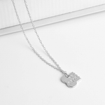 silver half dog bone hanging on a silver necklace chain