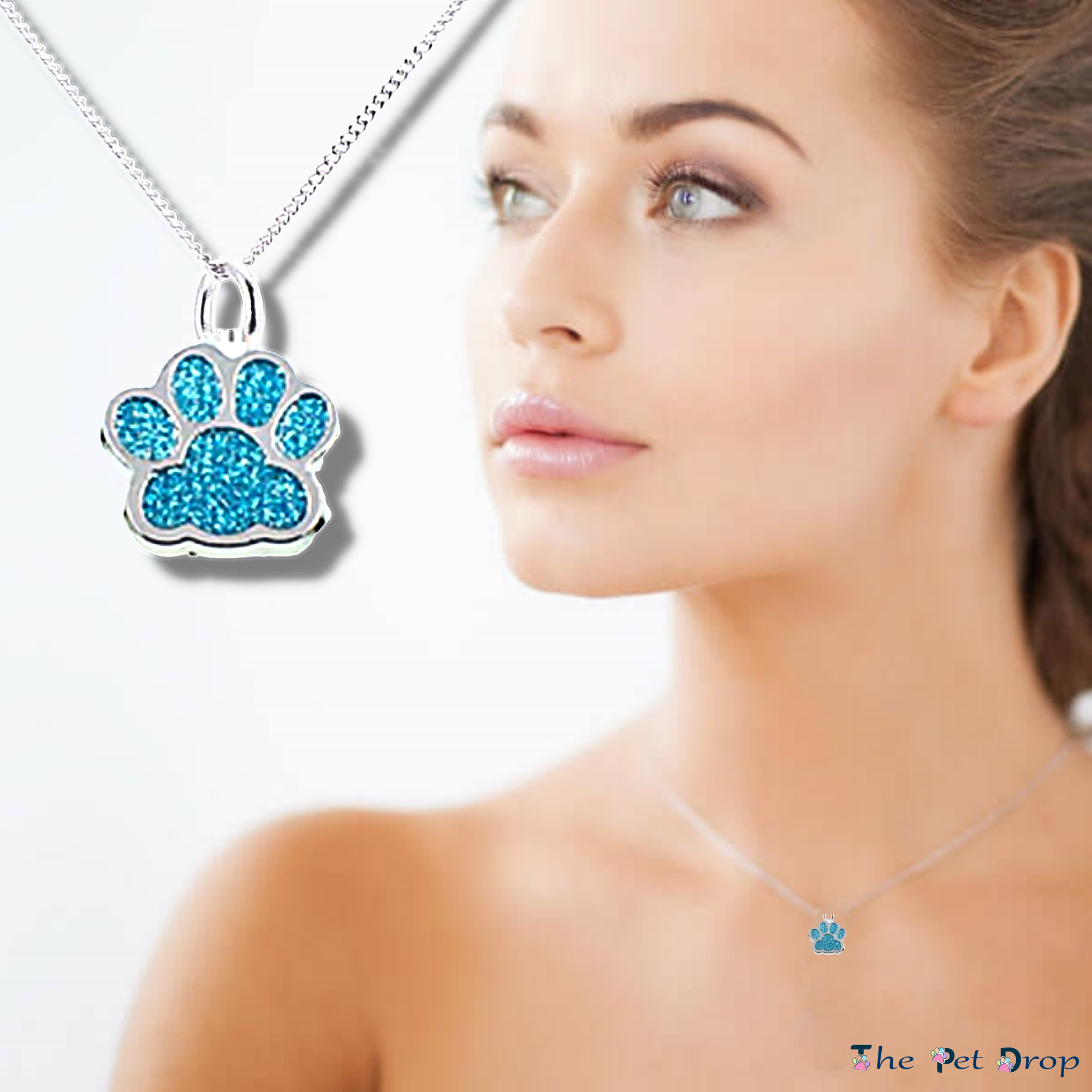 blue crystal paw print silver pendant hanging on a silver chain on a woman's neck