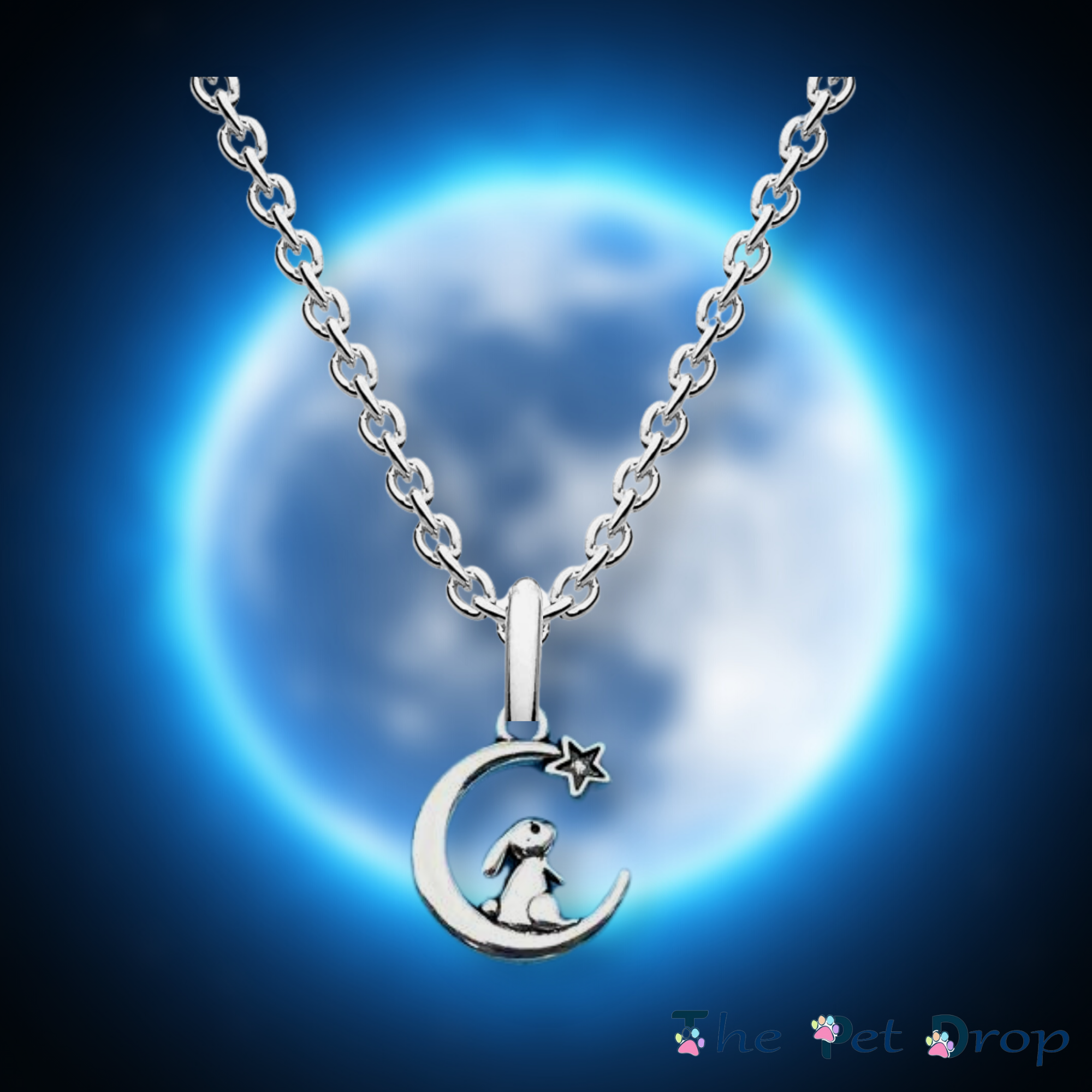 silver bunny rabbit sitting on the moon with a star on it. silver pendant hanging on a silver chain.