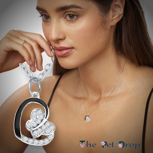 silver crystal butterfly  pendant on a silver crystal heart hanging on a silver chain on a woman's neck