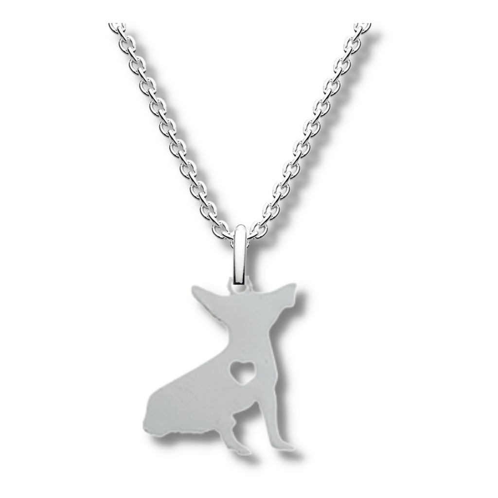 silver sitting chihuahua pendant with a heart shaped hole in its heart hanging on a silver chain.