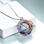 colourful crystal circle with one silver dolphin and a smaller rose gold dolphin in and around the circle pendant hanging on a silver chain.