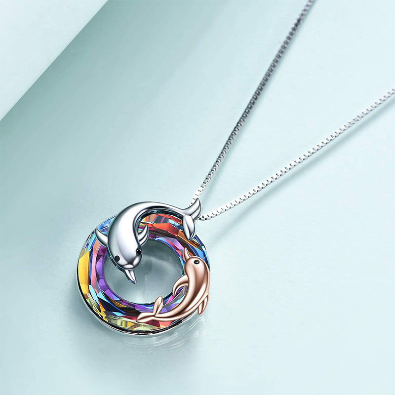 colourful crystal circle with one silver dolphin and a smaller rose gold dolphin in and around the circle pendant hanging on a silver chain.