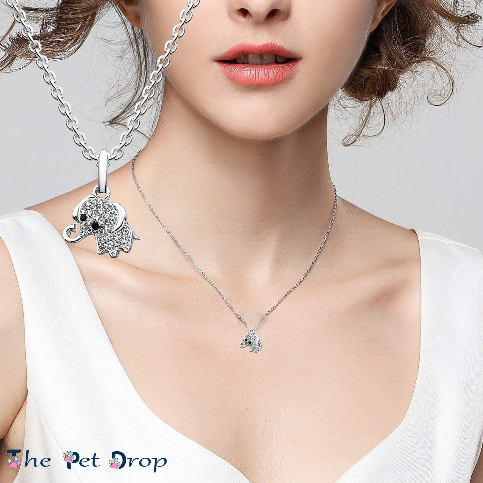 cute little crystal silver elephant hanging on a silver chain on a woman's neck.