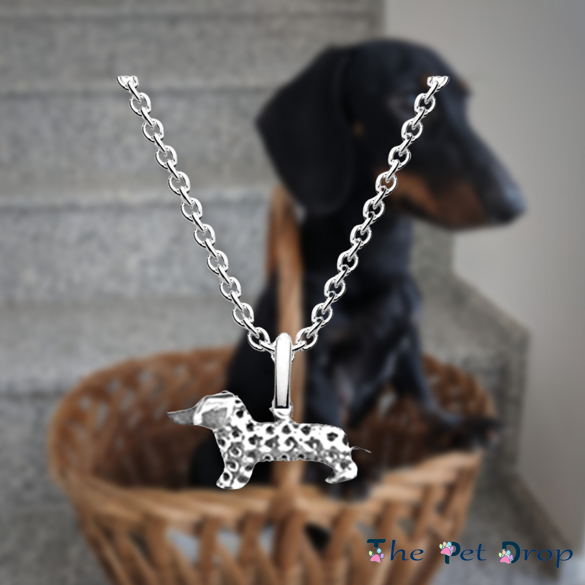 silver 3d little standing dachshund pendant with hole patterns all over its body excluding his head hanging on a silver chain.