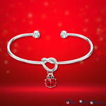 Forever Ladybird Bangle on a red background 