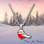 red breasted white robin on a gold pendant and hanging on a silver chain.