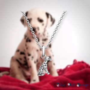 sitting silver Dalmatian pendant hanging on a silver chain   