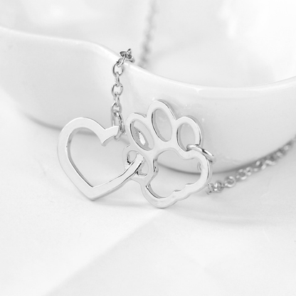 silver heart shape attached to a paw print shape hanging from a silver chain on each side