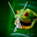 cute climbing frog silver pendant hanging on a silver chain.